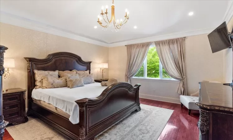 Bedroom featuring recessed lighting, crown molding, wood finished floors, baseboards, and an inviting chandelier