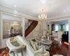 Living room featuring stairway, ornamental molding, and wood finished floors