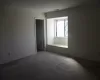 Unfurnished room with visible vents and carpet flooring