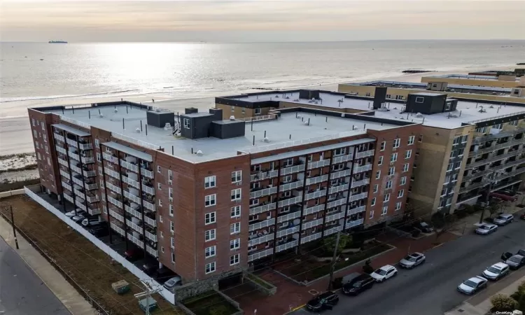 Drone / aerial view with a water view and a view of the beach