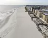 Aerial view featuring a water view and a beach view