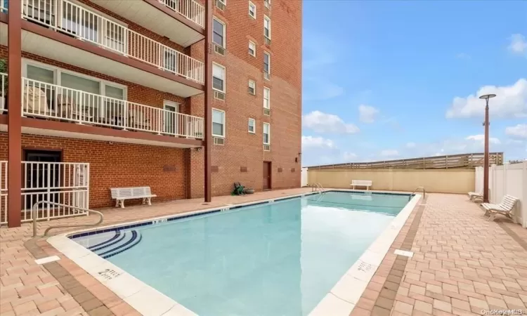 Pool featuring a patio and fence