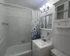 Full bath featuring toilet, vanity, tile walls, and shower / bathtub combination with curtain