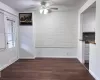 Unfurnished dining area featuring dark wood-style floors, baseboards, and a textured ceiling