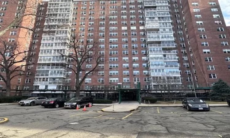 View of building exterior featuring uncovered parking