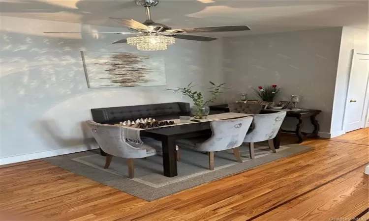 Dining space featuring baseboards and wood finished floors