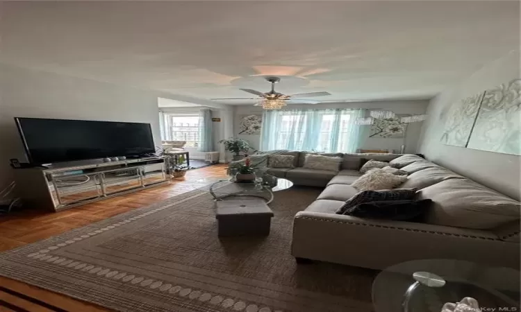 Living room featuring a ceiling fan and plenty of natural light