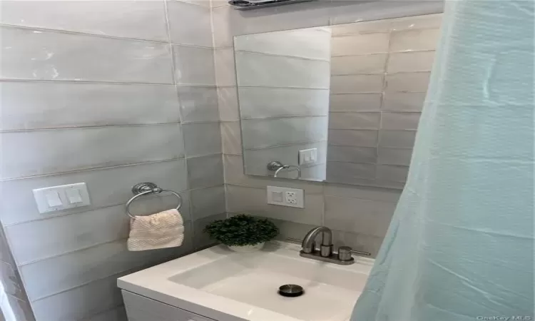 Full bathroom with a shower with curtain and a sink