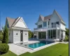 Back of house featuring a yard, a patio, a balcony, an outdoor pool, and an outdoor living space