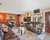 Carpeted living room featuring an AC wall unit, visible vents, and a fireplace