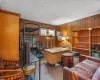 Office area with carpet floors and wooden walls