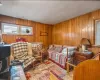 Sitting room featuring wood walls