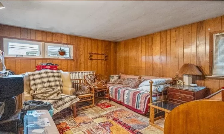 Sitting room featuring wood walls