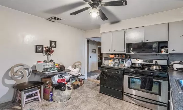 Kitchen with black appliances, ceiling fan, and visible vents