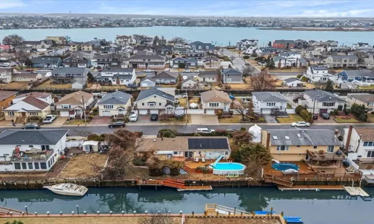 Drone / aerial view featuring a water view and a residential view