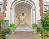 Doorway to property featuring brick siding