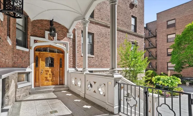 Doorway to property featuring brick siding