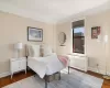 Bedroom featuring radiator, baseboards, and wood finished floors