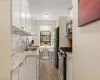 Kitchen featuring white cabinetry, tasteful backsplash, appliances with stainless steel finishes, and a sink