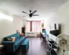 Office area with radiator heating unit, ceiling fan, and wood finished floors