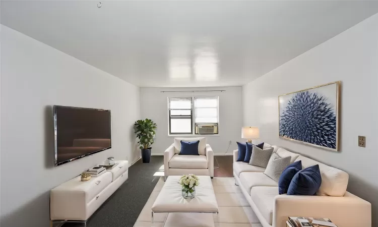 Living room featuring baseboards and cooling unit