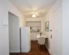 Kitchen featuring white appliances, a sink, light countertops, backsplash, and built in desk