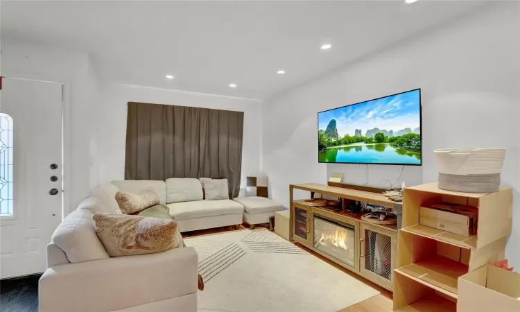 Living room featuring wood finished floors and recessed lighting