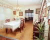 Carpeted dining area featuring a chandelier and crown molding