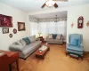 Living area with a ceiling fan and carpet flooring