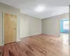 Unfurnished room with radiator, baseboards, and wood finished floors