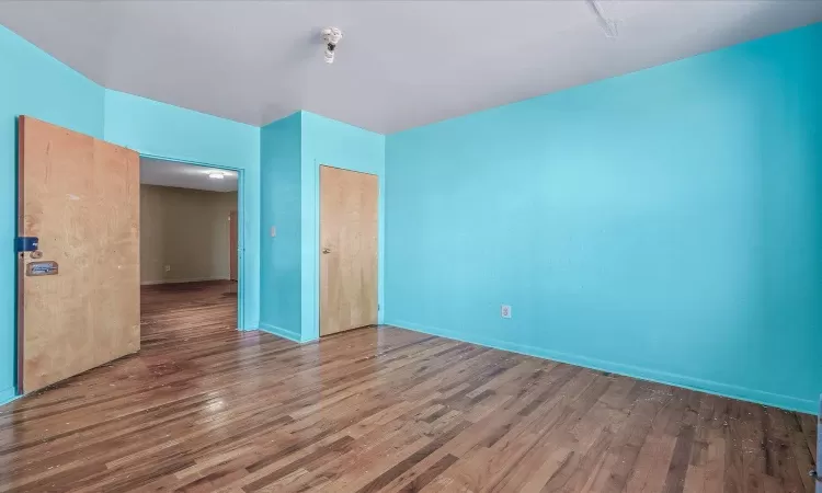 Empty room featuring baseboards and wood finished floors