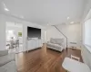 Bedroom featuring a closet, baseboards, lofted ceiling, wood finished floors, and a notable chandelier