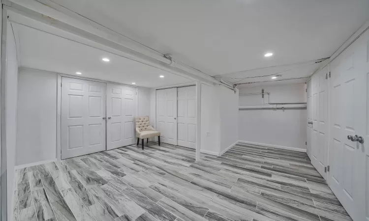 Dining area with radiator, light tile patterned floors, baseboards, and a wall mounted AC