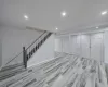 Living area featuring crown molding, baseboards, dark wood-style flooring, and recessed lighting