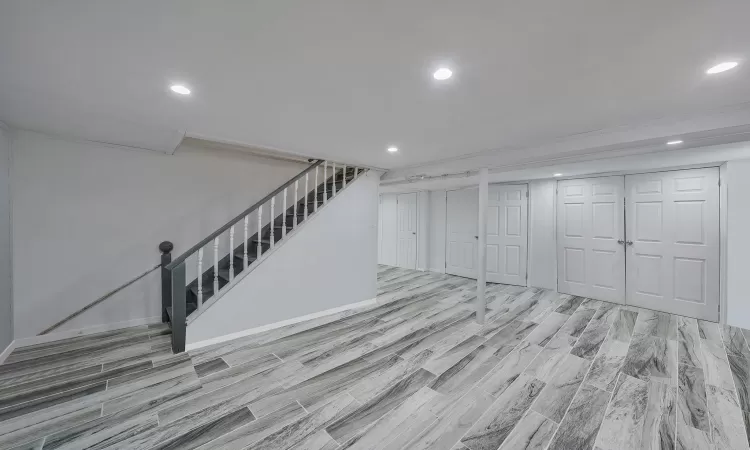 Living area featuring crown molding, baseboards, dark wood-style flooring, and recessed lighting