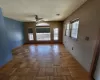 Living room featuring visible vents, a ceiling fan, and baseboards