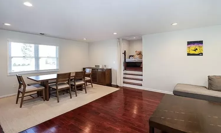 Dining space featuring recessed lighting, wood-type flooring, visible vents, and baseboards