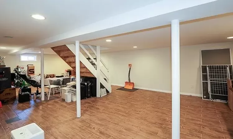 Below grade area featuring recessed lighting, baseboards, and wood finished floors