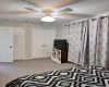 Carpeted bedroom featuring a ceiling fan, baseboards, visible vents, and a closet