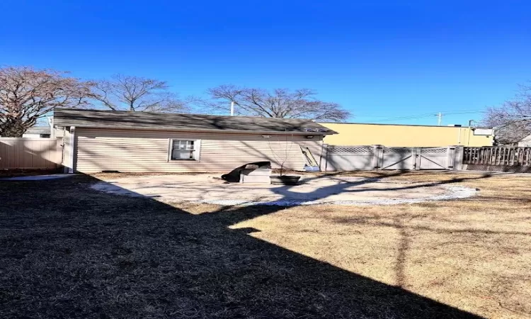 Back of house with a gate and fence