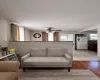 Living area featuring light wood finished floors, plenty of natural light, and ceiling fan