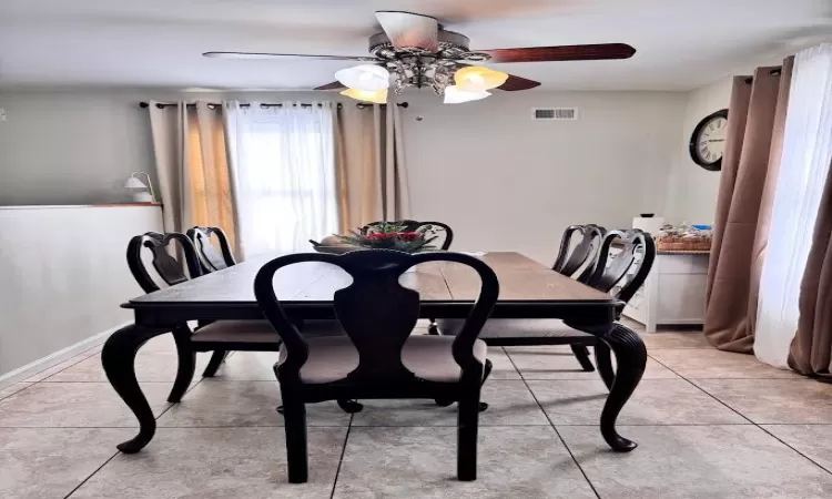 Dining space with visible vents and light tile patterned flooring