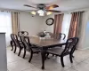 Dining area with a ceiling fan, visible vents, and light tile patterned flooring