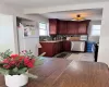 Kitchen with light stone counters, decorative backsplash, freestanding refrigerator, a sink, and dishwasher