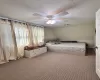 Carpeted bedroom with ceiling fan and visible vents