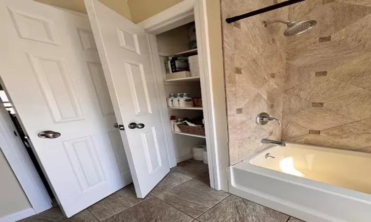 Bathroom with shower / bathing tub combination and toilet