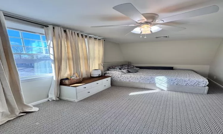 Unfurnished bedroom with carpet flooring, visible vents, ceiling fan, and baseboards