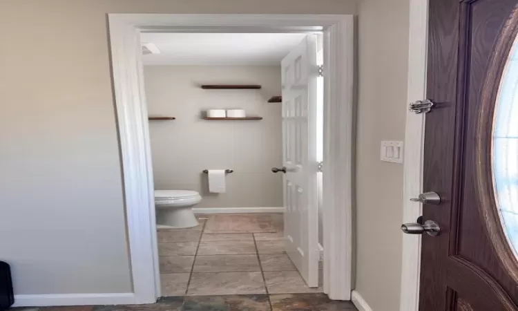 Bathroom with toilet and baseboards