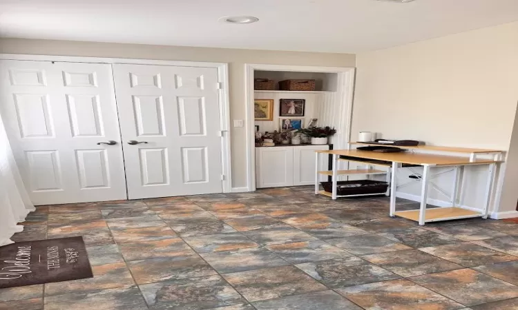 Home office featuring stone finish floor and baseboards