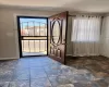 Foyer with stone finish flooring and baseboards